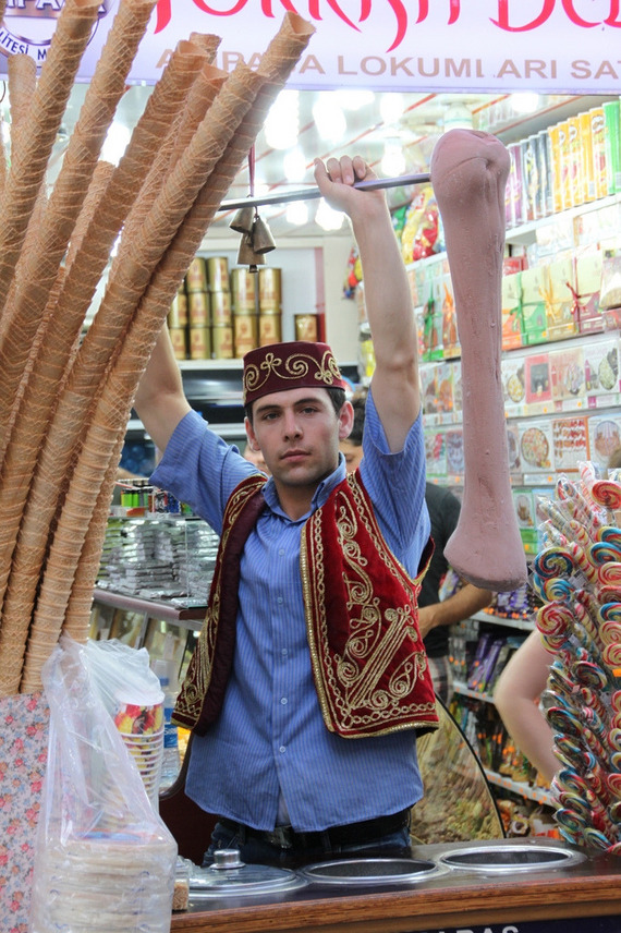 A Turkish ice cream vendor performs tricks with the gooey confection.